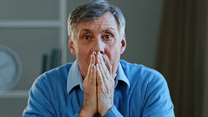 Depressed frustrated old senior Caucasian man shocked sad elderly mature 60s male feeling worried...