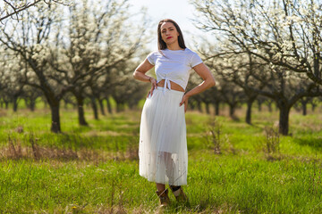 Beautiful woman in a plum orchard in bloom