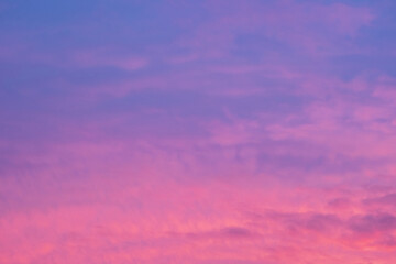 Bright colored clouds on dramatic sunset sky horizontal background.