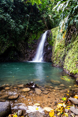 Seven Sisters Waterfalls in Grenada Grand Etang National Park. One of Grenada's most beautiful areas where a waterfall rushes down the mountainside into a large pool perfect for swimming. Slow shutter - obrazy, fototapety, plakaty