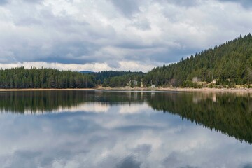 dam reflection dramatic sky and mountains