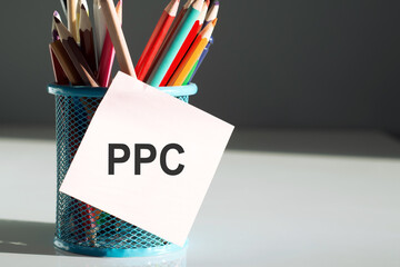 Stickers with pencils with text PPC on the white table background