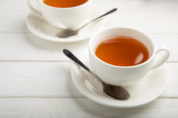 Cup of green organic tea on white texture wood.Tea ceremony. View from above. Copy space