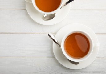 Cup of green organic tea on white texture wood.Tea ceremony. View from above. Copy space