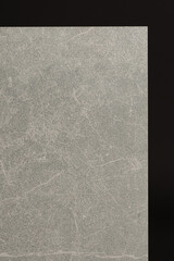 Fototapeta premium Porcelain tiles with a stone texture on a dark gray background