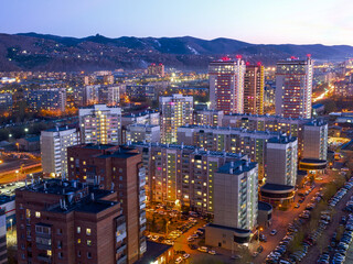 Siberian city of Krasnoyarsk. Top view of the Right Bank and mountains. Evening shooting
