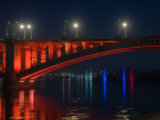 Naklejka na ściany i meble Siberian city of Krasnoyarsk. Night view of the Yenisei River. Communal bridge