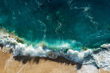 Fototapeta premium Aerial view of tropical ocean with waves in Nusa penida Bali Indonesia