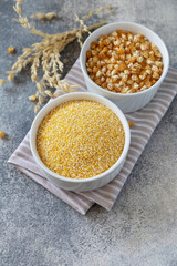 Food and baking gluten-free protein ingredient Сorn flour wholesome and raw corn over gray stone table. Copy space.