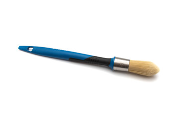 Round brush with a profiled tip for trimming, with natural bristles. Blue handle. Isolated on white background.