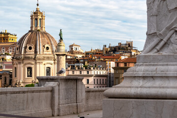 View Victor Emmanuel II monument at Piazza Venezia on dome of the Santa Maria di Loreto church and dome of Most Holy Name of Mary at Trajan Forum. Landmark in the city of Rome, Lazio, Italy, Europe