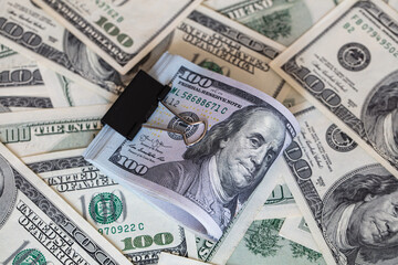 100 dollar banknotes with binder clip on dollars background