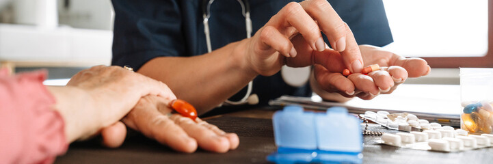 A close-up shot of pills prescribed by a doctor to an elderly woman