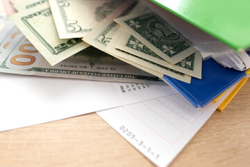 office folders close-up, american dollars banknotes, concept of filling out tax return, paying taxes, Corporate business income, expenses, maintaining household expenses, Gearing Up for Startups