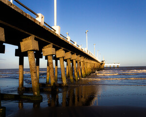 pier on the beach at sunset