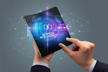 Businessman holding a foldable smartphone, technology concept