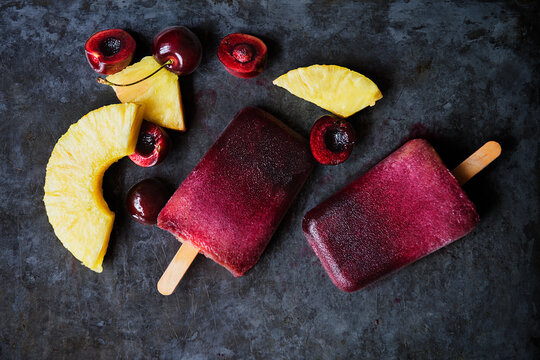 Cherry pineapple popsicles with ingredients 