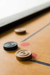 A game of carrom with scattered stones at a corner of the board - obrazy, fototapety, plakaty