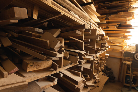 Interior of workshop with stack of wood on rack, copy space