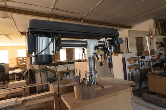 Interior of woodworking workshop with manufacturing equipment and wood