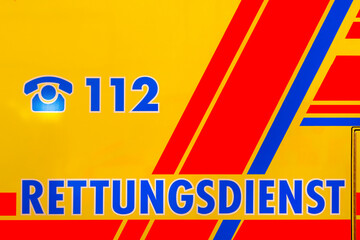 Emergency number 112 with writing rescue service - Rettungsdienst on a vehicle
