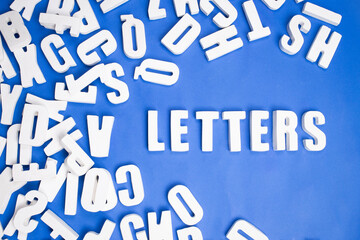 Loose white letters on blue background forming the word letters. Loose white letters on blue...