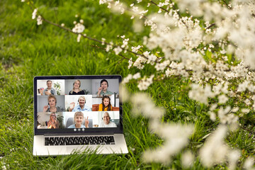 video conferencing on laptop PC in the garden on vacation in summer.
