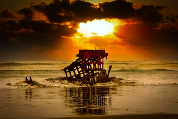 Rusting metal from abandoned shipwreck dramatic sunset