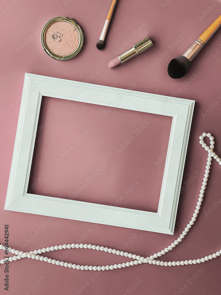 Wall mural Horizontal art frame, make-up products and pearl jewellery on blush pink background as flatlay design, artwork print or photo album