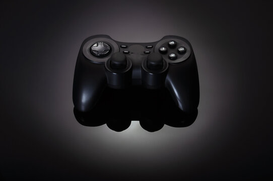 Black game joystick, gamepad on a black gradient background
