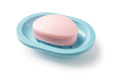 Pink soap bar in a teal blue dish isolated on a white background. Oval shaped bar of soap on a plastic holder for bathroom and shower. Purity, toiletries and washing hands concepts.