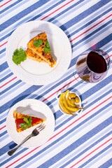 Traditional Spanish snack tortilla patatas served with red piquillo pepper and a glass of wine.