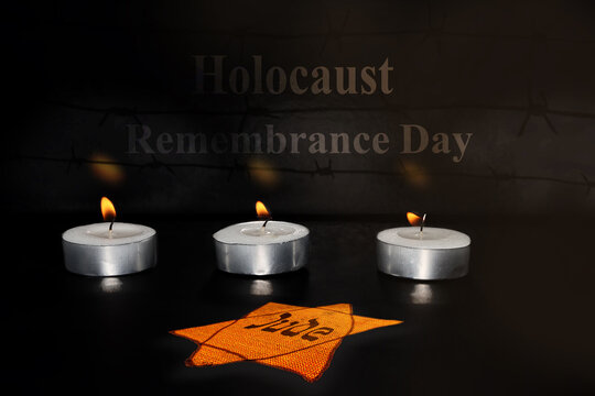Holocaust Remembrance Day. Image for Holocaust Memorial Day, Holocaust Remembrance Day. Foreground - burning text and a Jewish Star (Jewish or Yellow Badge), background - burning memorial candles