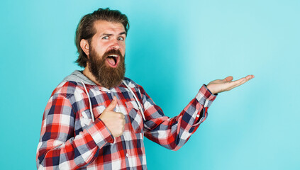 Happy bearded man holds something on open hand palm and showing thumb up. Season sale and discount.