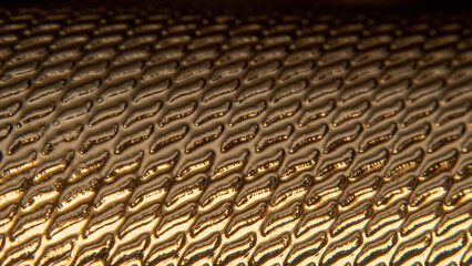 Abstract wavy relief pattern of gilded surface