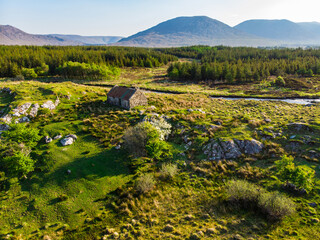 Beautiful aerial sunset view of Connemara region in Ireland. Scenic Irish countryside landscape with magnificent mountains on the horizon, Ireland