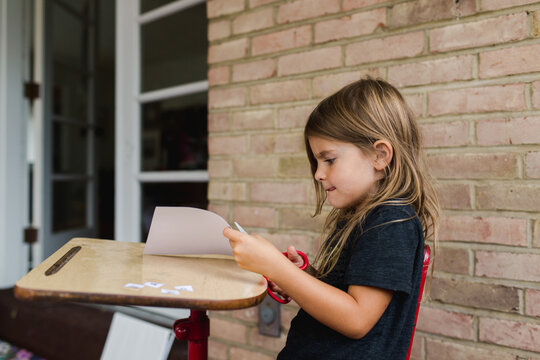 little girl practices cutting