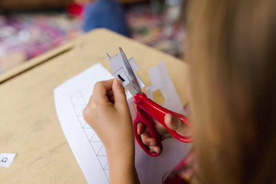 little girl practices cutting