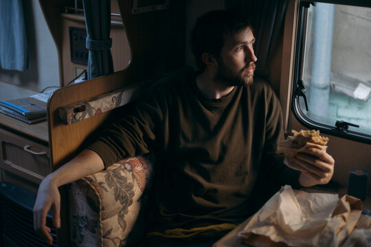 man with food in her hand
