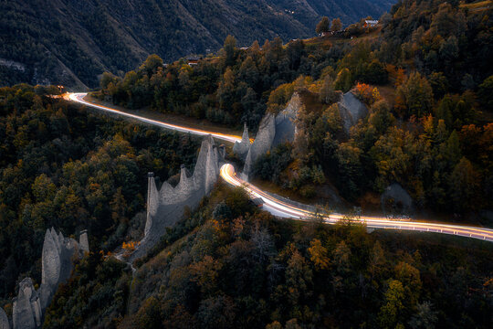 Long exposed traffic light trails on mountain road.