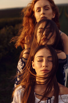 Close up in a row of faces of three different women with