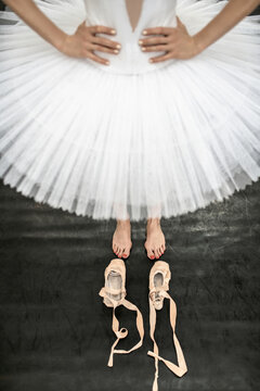 Female ballet dancer posing inside dance hall