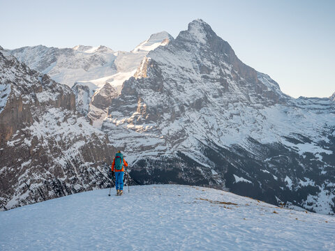 Ski mountaineer in front of Eiger mountain in the alps