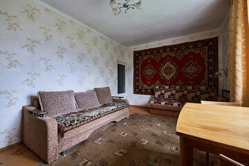 Example of Old Soviet Russian poor interior in Khruschev House. Aged  sideboard, table, chairs....