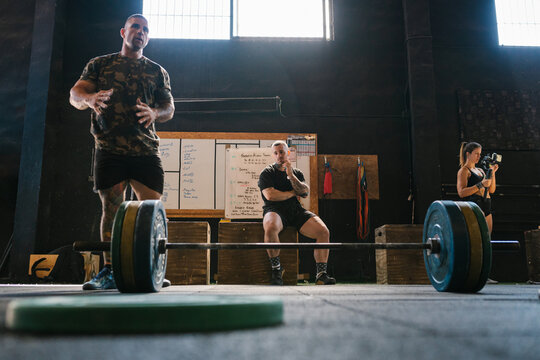 crossfit trainer giving directions in the gym