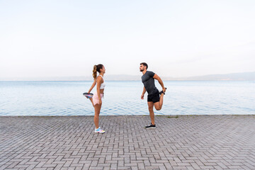 Couple Stretching Before Their Workout