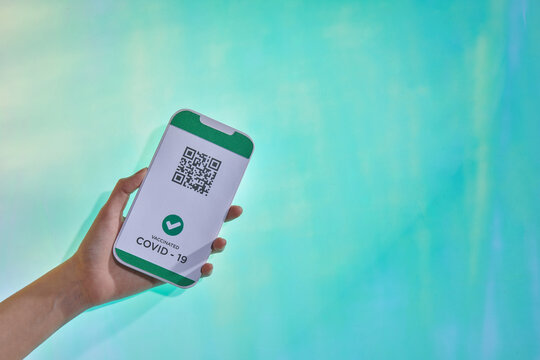 Vaccinated person hand holding mobile phone
