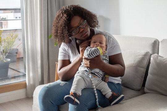 worried mother checking health of her small baby at home, worry