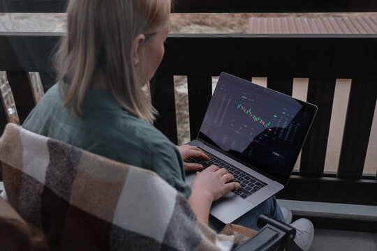 Female broker using laptop on balcony