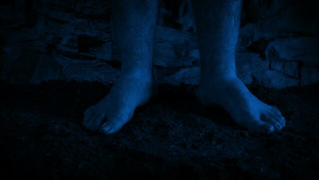 Man Stands Barefoot In The Dark